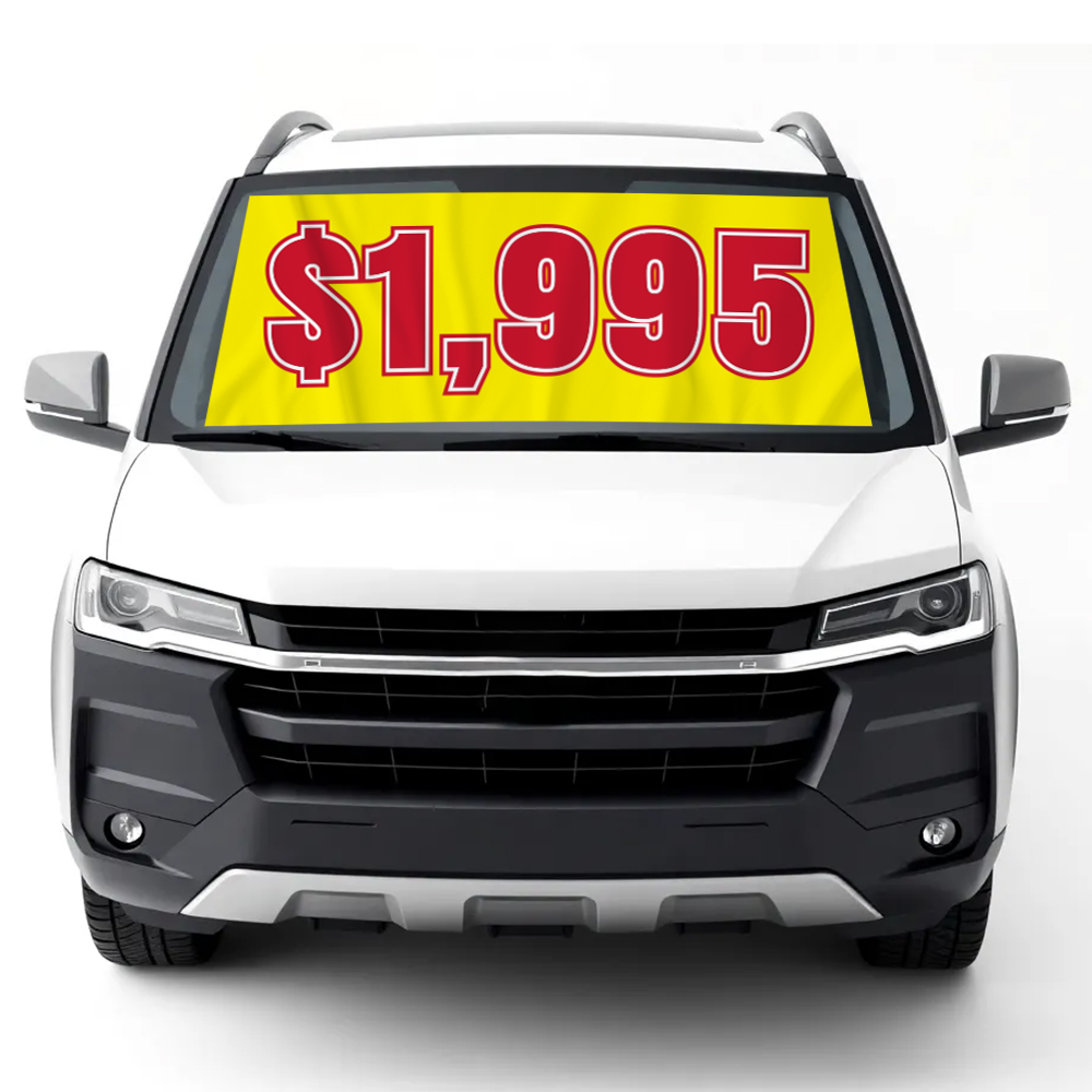 Red and yellow windshield banner with $1,995 displayed on vehicle